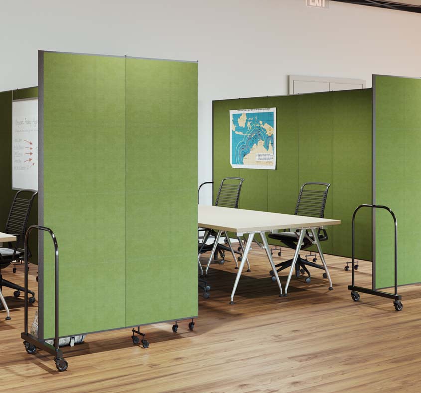 Green room dividers partially surround a table and chairs